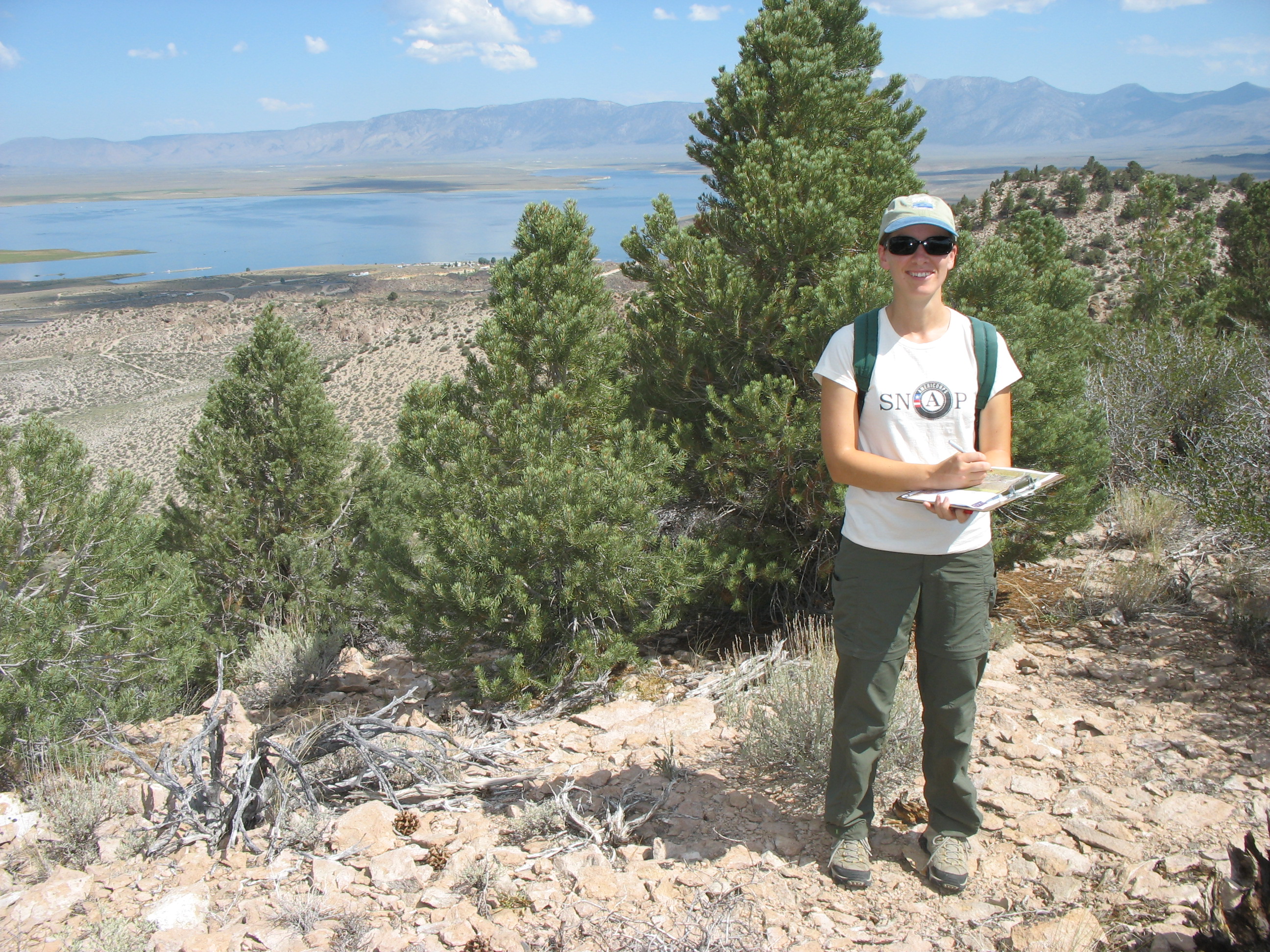 Serena assisting Aaron with easement monitoring on the Crowley Hilltop Preserve, with Crowley Lake in the background. 