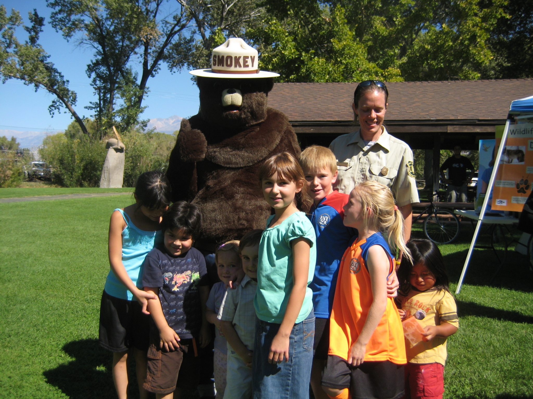 A group of Smokey the Bear fans pose for a photograph. A group of Smokey the Bear fans pose for a photograph.