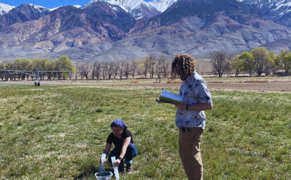 Paiz and Ostergaard in the field, taking soil samples.